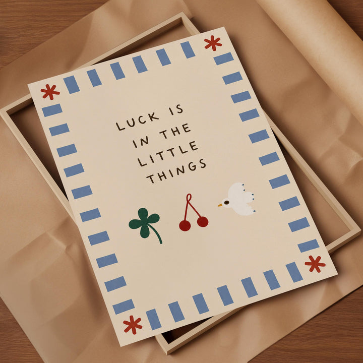 a framed card with a message that reads " Luck is in the little things".