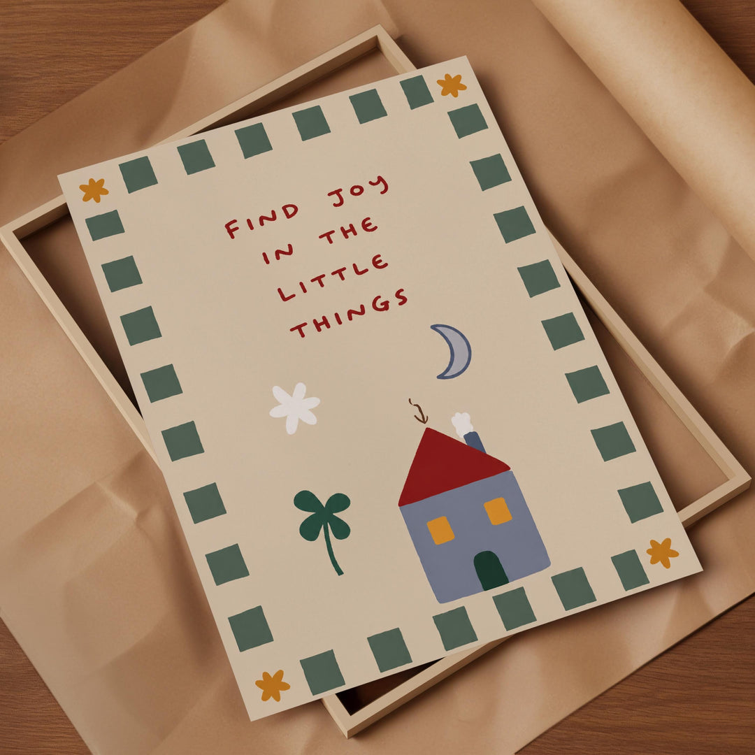 a card with a house and a tree, along with the text "Find joy in the little things" written on it.