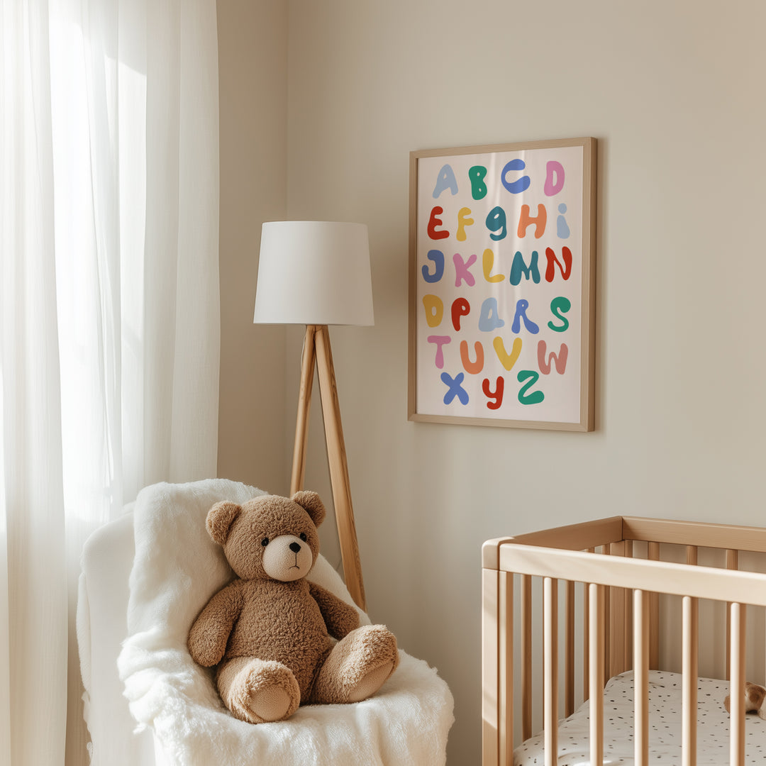 a teddy bear sitting in a chair next to a crib