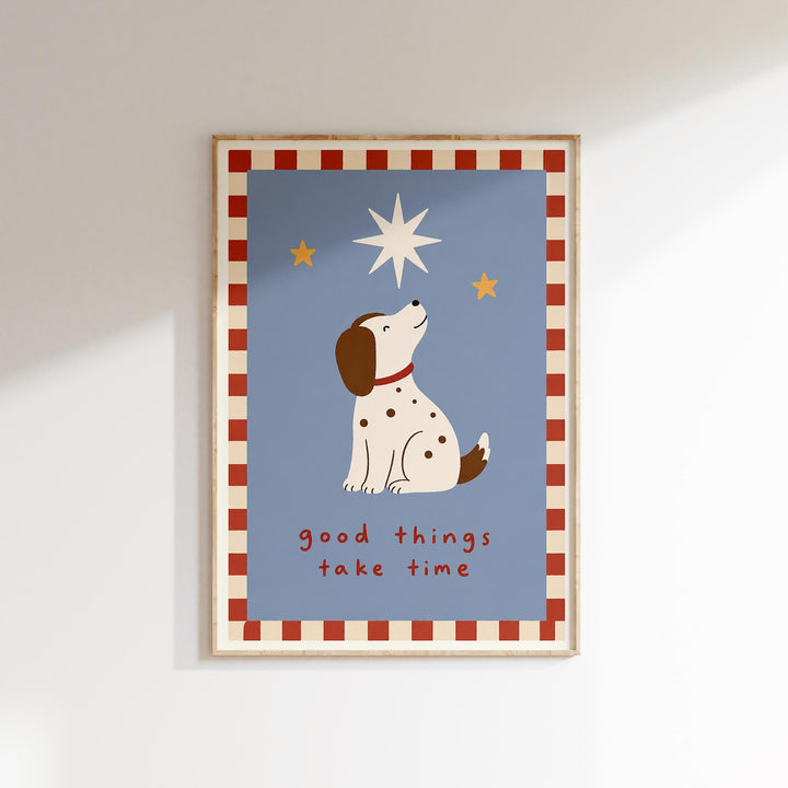 A framed poster with a cartoon dog looking up at the stars, accompanied by the text "Good things take time".