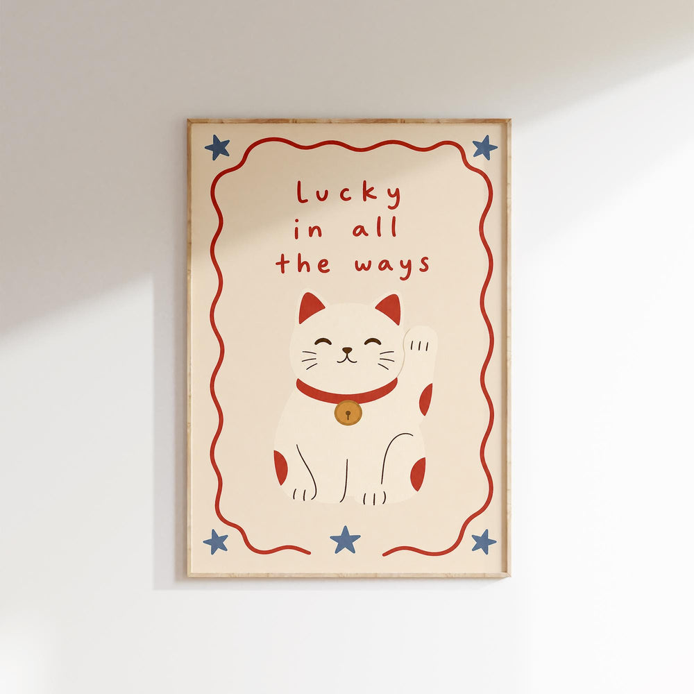 A framed poster with a white cat and the text "Lucky in all the ways" written on it.
