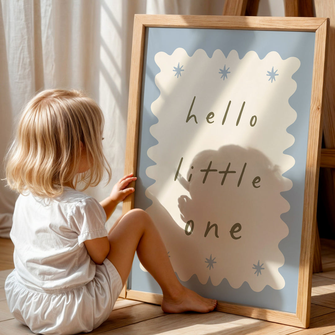a little girl sitting on the floor next to a sign