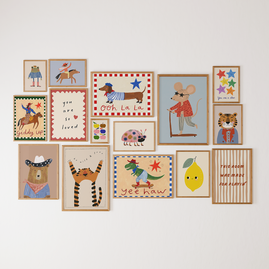 Gallery wall of colorful animal, cowboy, fruit and quote prints from the 106-image digital bundle