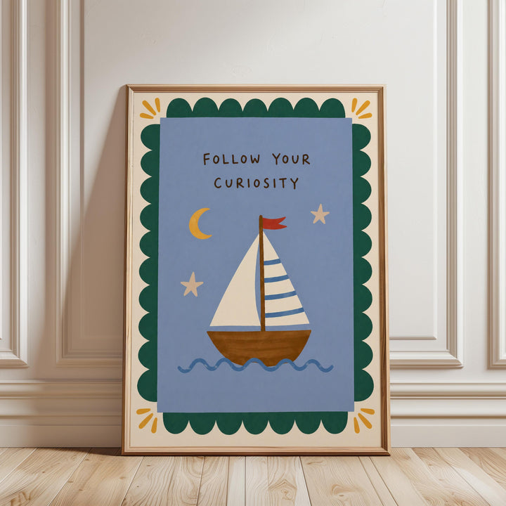 a framed poster with a sailboat illustration and the text "Follow Your Curiosity" on it.