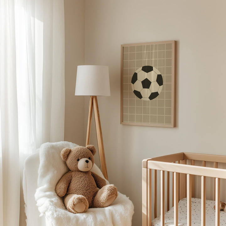 a teddy bear sitting in a chair next to a crib