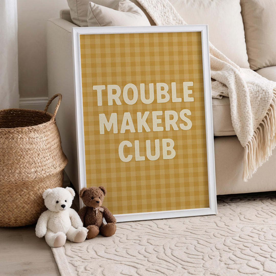 a couple of teddy bears sitting next to a poster