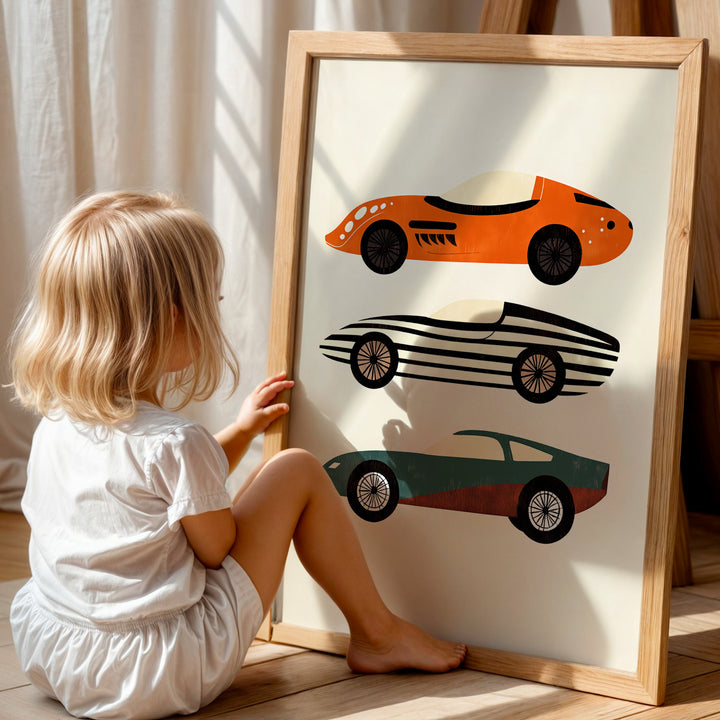 a little girl sitting on the floor next to a poster