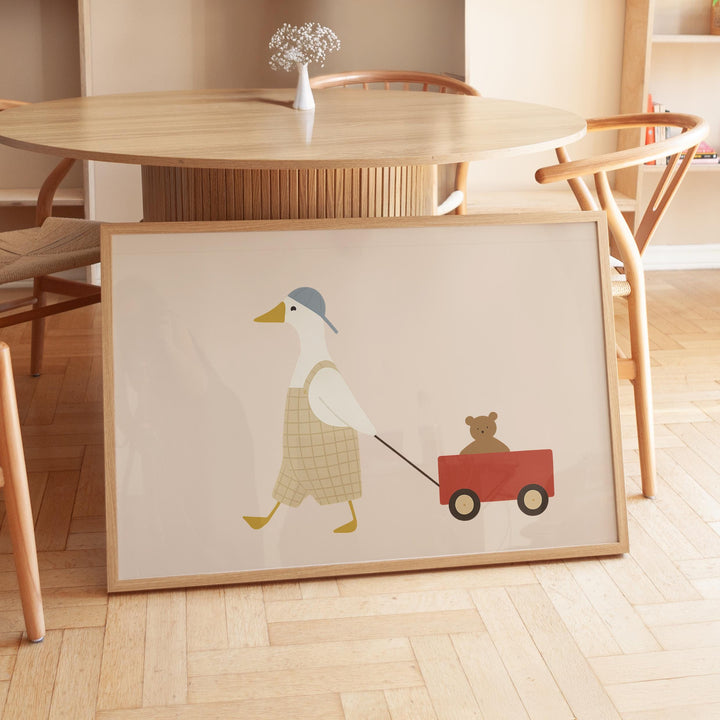 a picture of a duck pulling a bear on a wagon