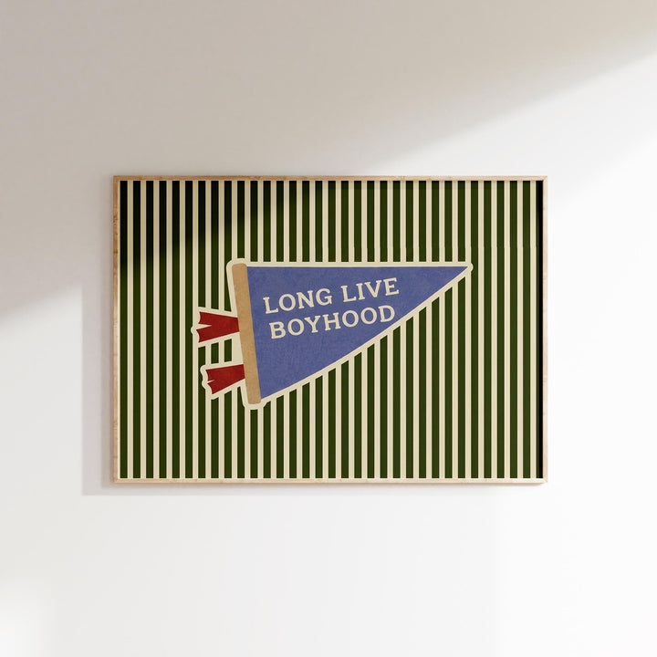 A framed poster with a green and white striped background and a blue triangular flag with the text "LONG LIVE BOYHOOD" displayed on it.