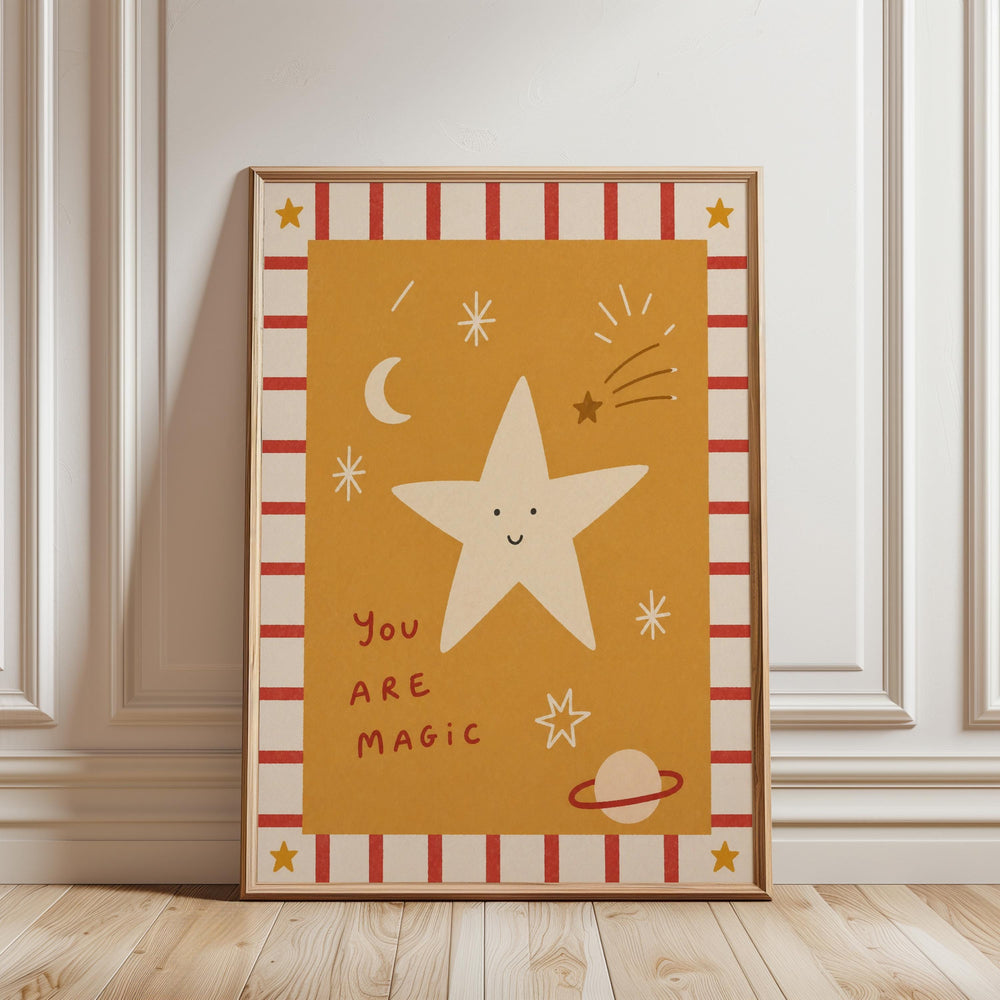 A framed poster with a star and various celestial objects, including a crescent moon, stars, and a planet, along with the text "You are magic".