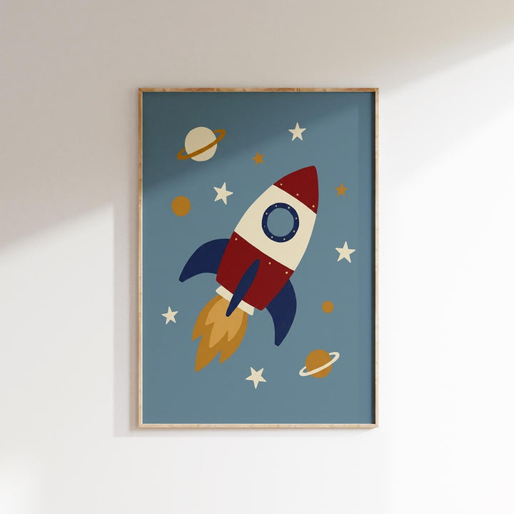 A framed poster depicting a red and white rocket ship soaring through a starry sky, with planets and stars in the background.