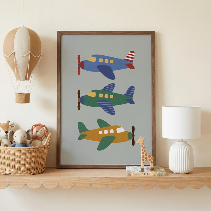 a shelf with a framed picture of three colorful airplanes, a basket of stuffed animals, and a lamp.