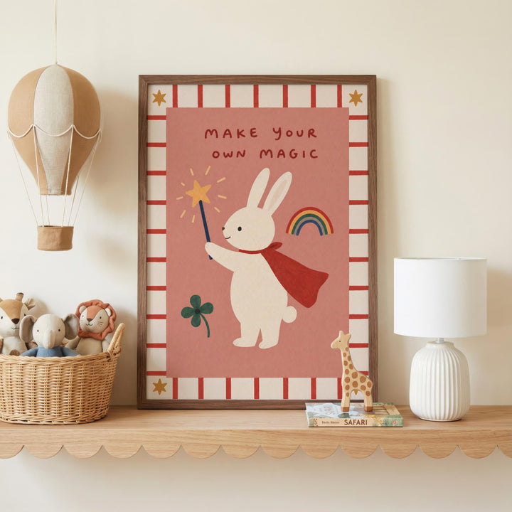 a shelf with a framed poster of a rabbit holding a wand and a rainbow, a hot air balloon, and a lamp. The poster also has the text "Make your own magic".