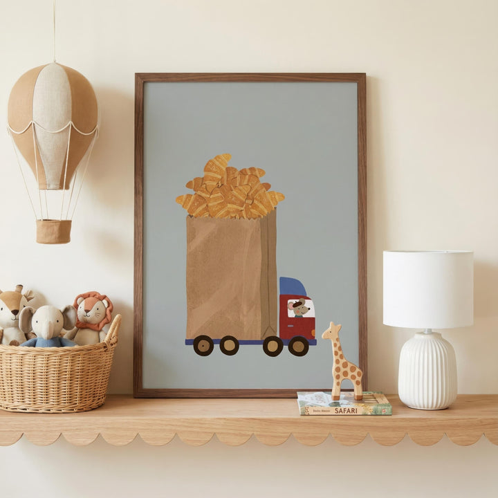 a shelf with a framed picture of a truck carrying a basket of pastries, a toy giraffe, a stuffed animal, and a lamp.