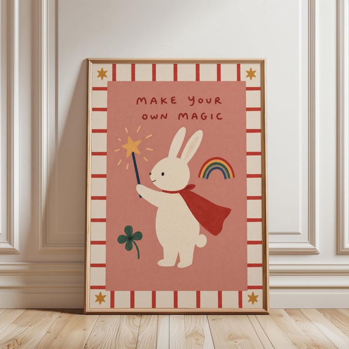 A framed poster with a cartoon rabbit holding a wand and a rainbow, along with the text "MAKE YOUR OWN MAGIC" and a clover.