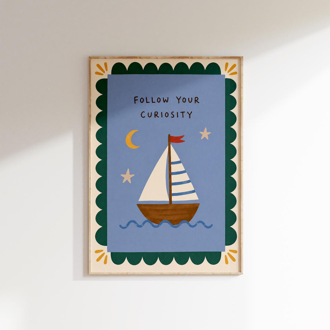 The image is a framed artwork depicting a sailboat on a blue background with a scalloped border and stars. The text "Follow Your Curiosity" is written above the sailboat.