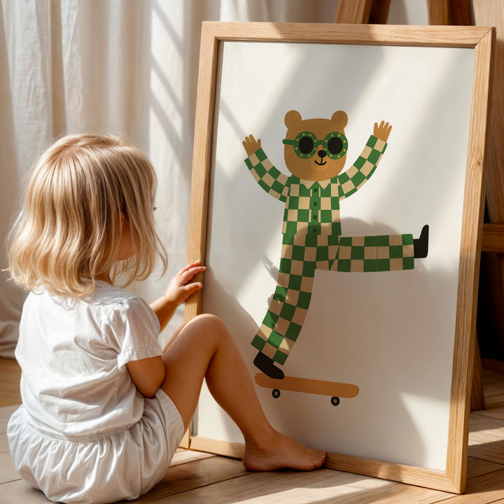 a little girl sitting next to a picture of a bear on a skateboard