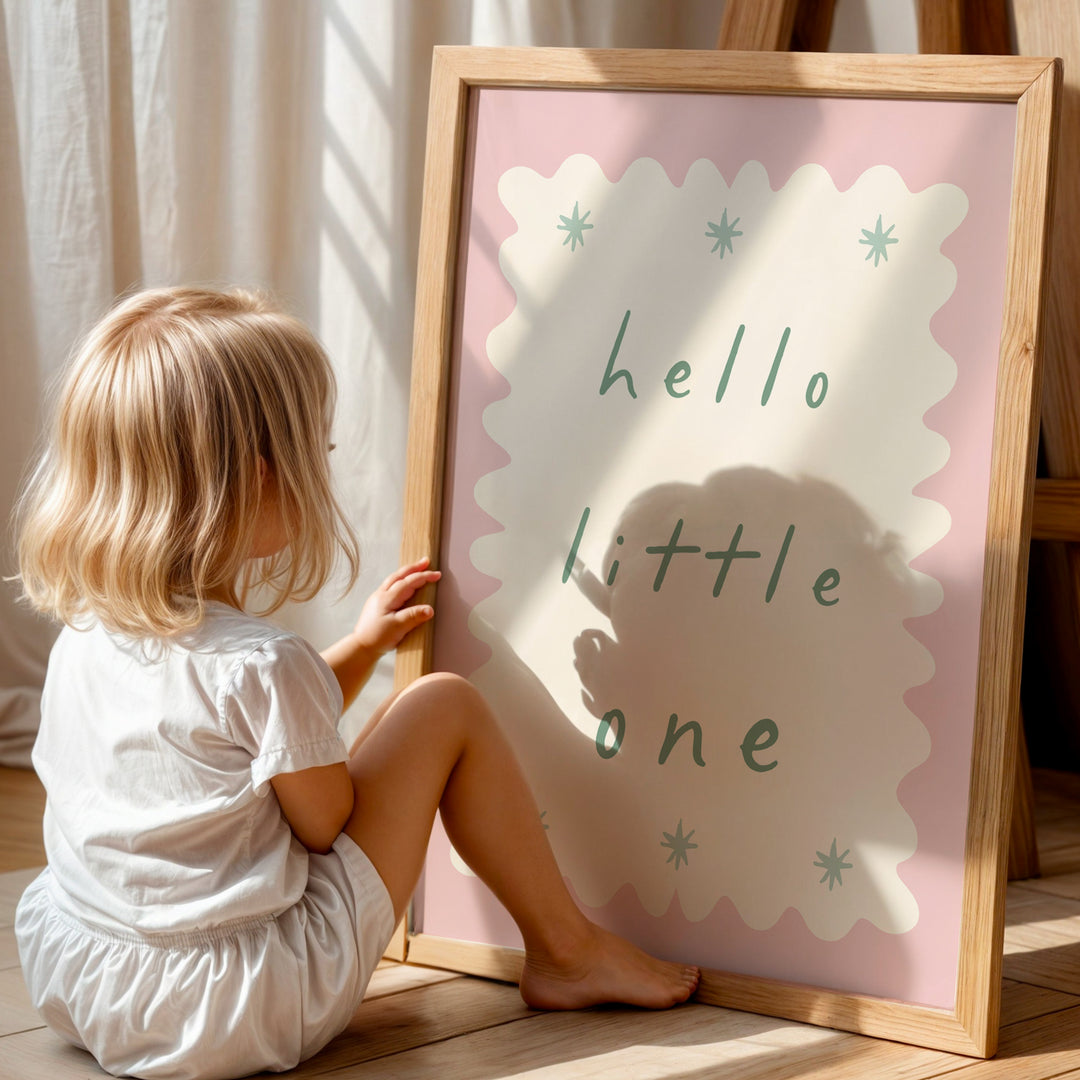 a little girl sitting on the floor next to a sign