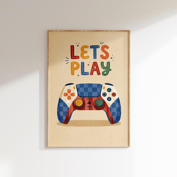 A framed poster with a colorful illustration of a game controller and the text "LET'S PLAY" written on it.