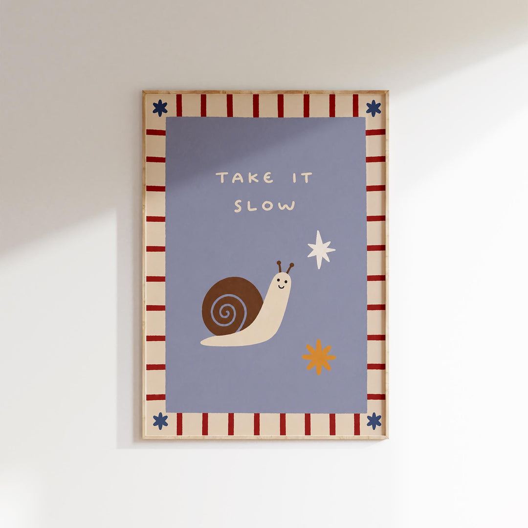 The image is a framed poster with a cartoon snail and a star, along with the text "TAKE IT SLOW" written on it.