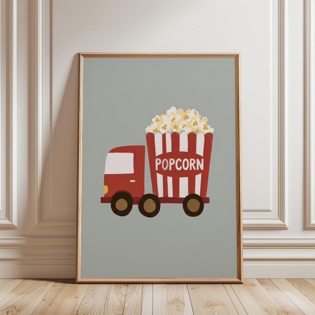 A framed illustration of a red and white popcorn truck with a large bucket of popcorn on the back, set against a light green background.