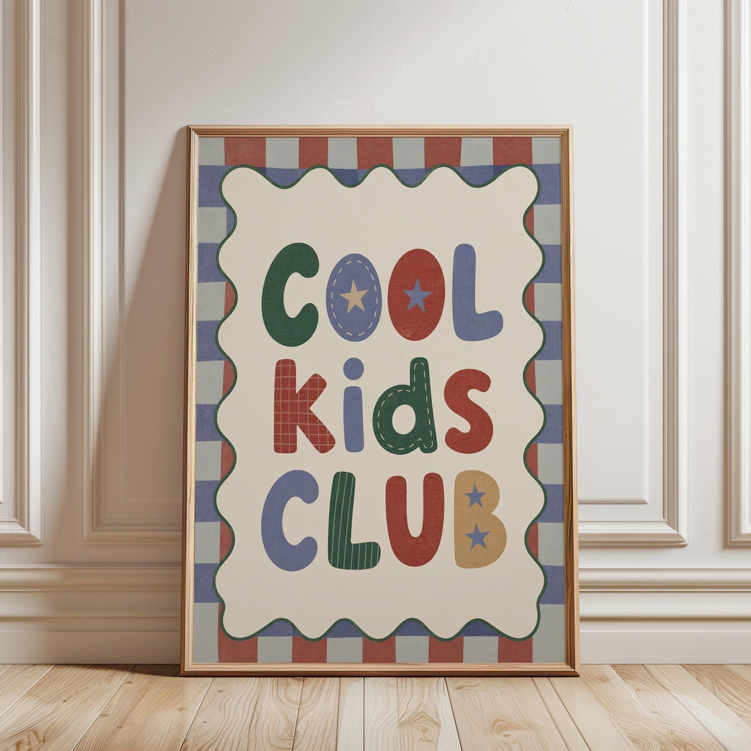A framed poster with the text "Cool Kids Club" displayed prominently in the center.