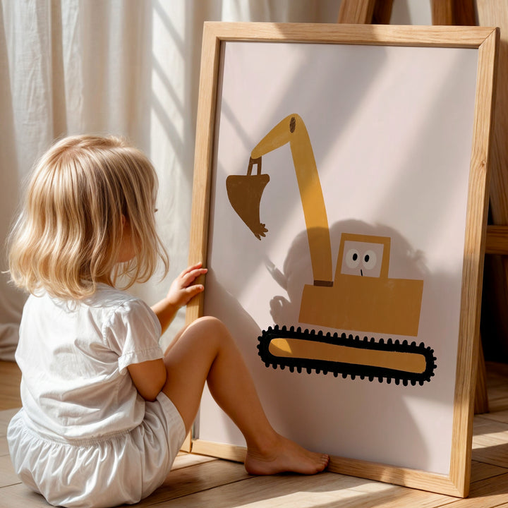 a little girl sitting on the floor next to a picture