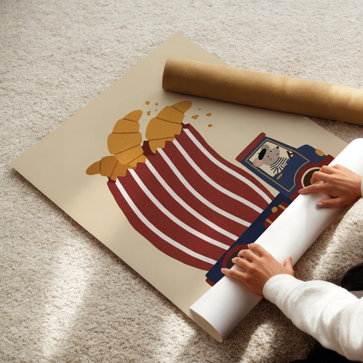 A person is rolling up a poster featuring a cartoon train with a cow on it.