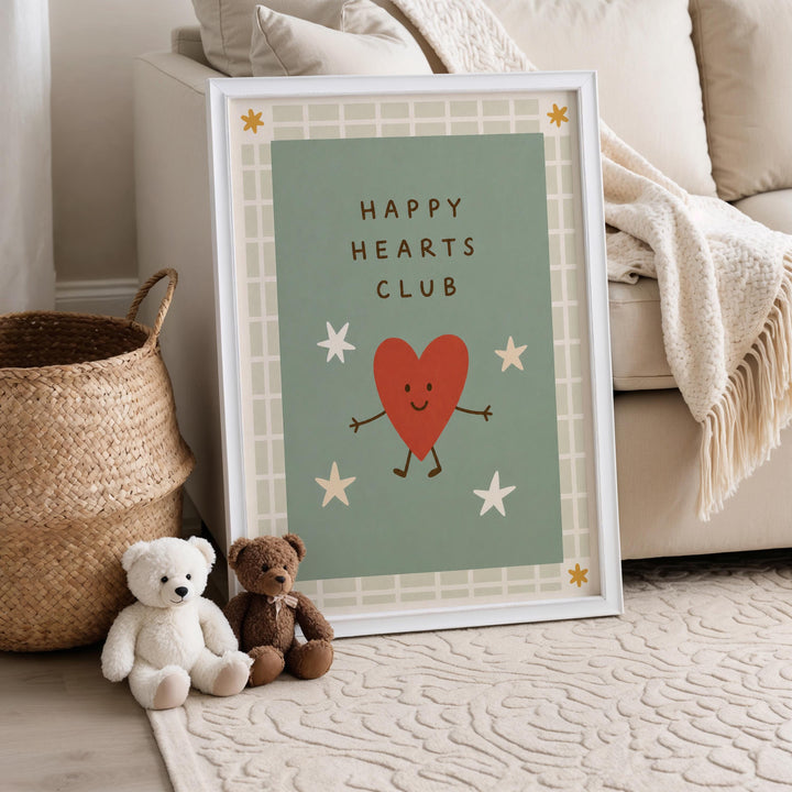 A framed poster with a cartoon heart and stars is displayed on a beige carpeted floor, accompanied by two stuffed teddy bears.