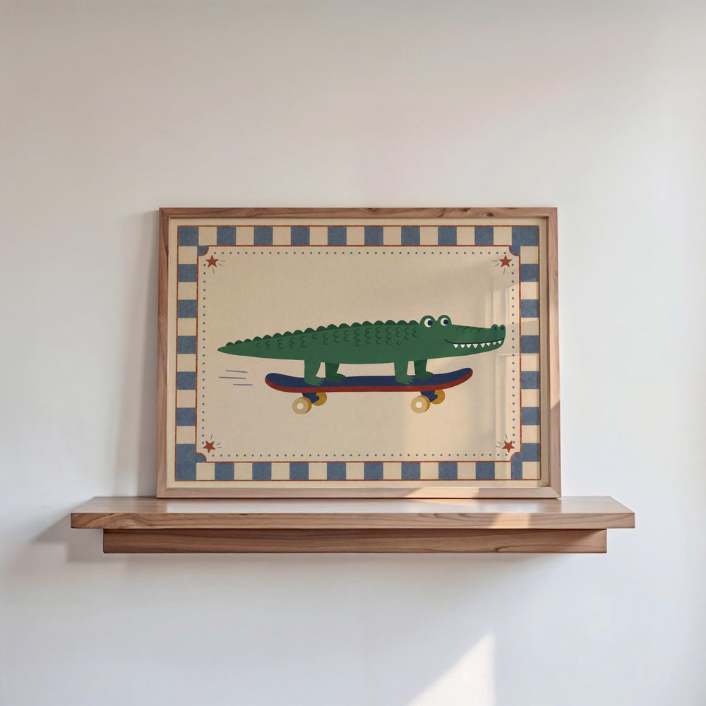 A framed picture of a green alligator riding a skateboard is displayed on a wooden shelf against a white wall.