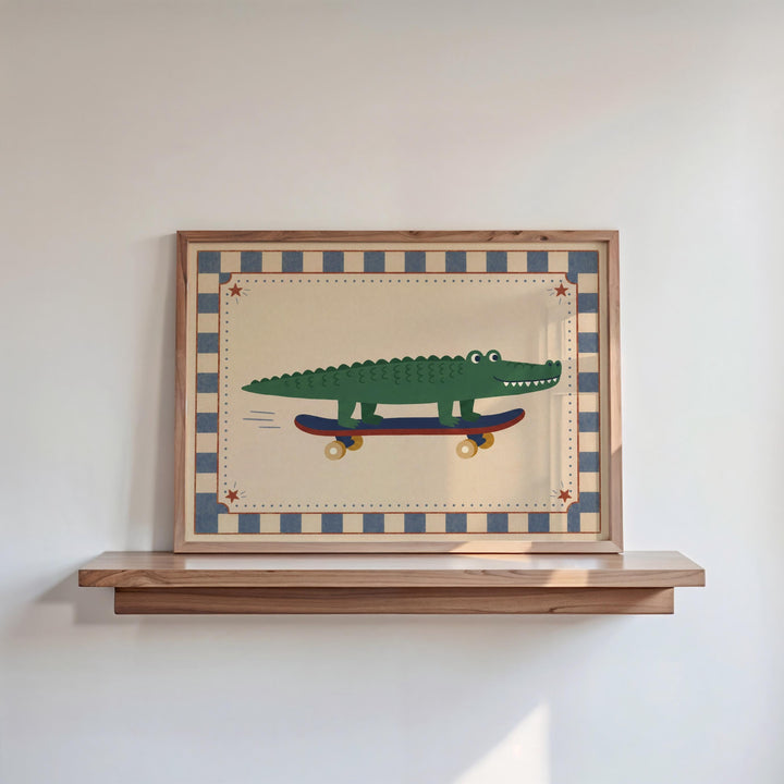 A framed picture of a green alligator riding a skateboard is displayed on a wooden shelf against a white wall.